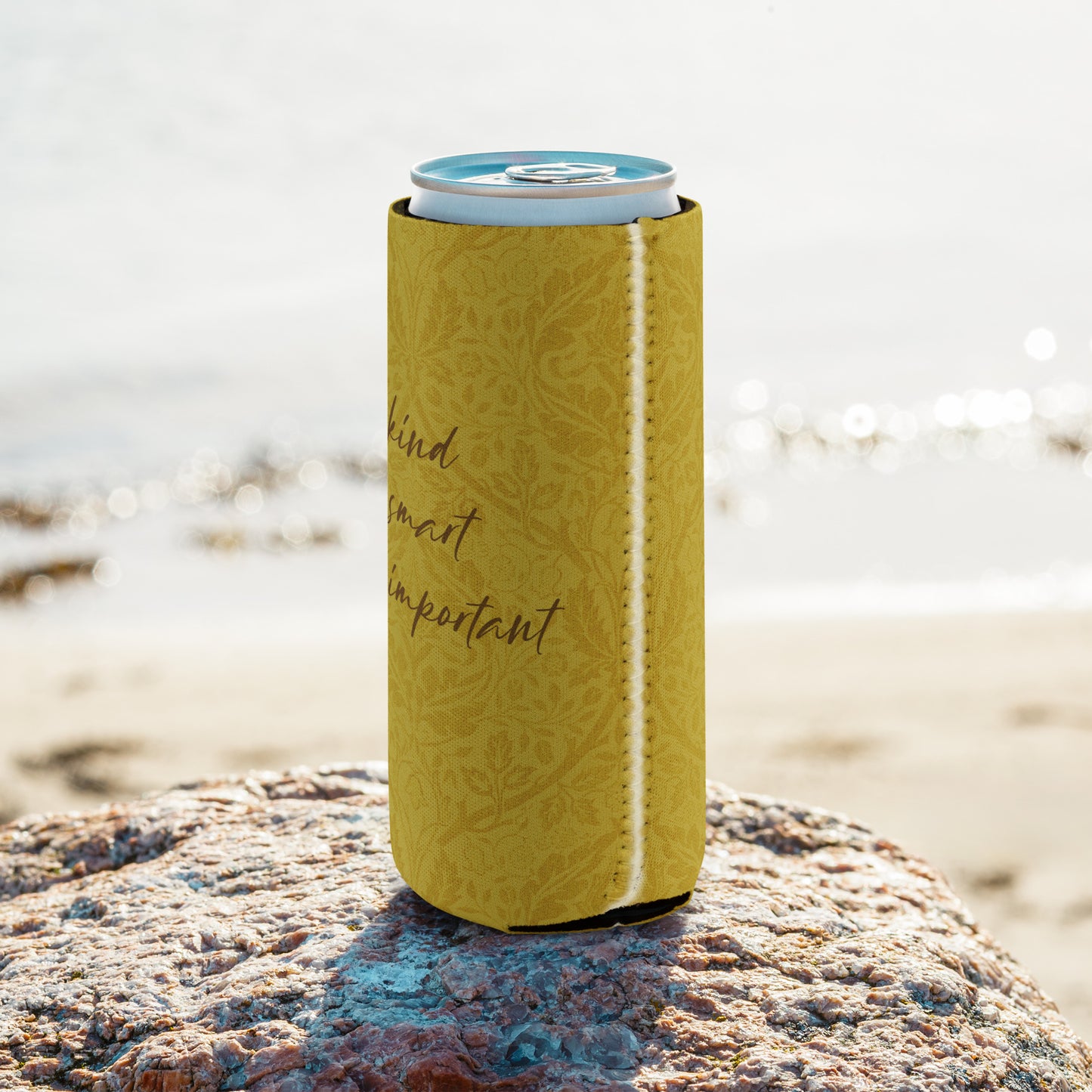 Slim can coozie with a mustard-colored, patterned background and 'Uke is kind, uke is smart, uke is important' printed on it.