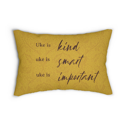 A throw pillow with a mustard-colored patterned background and 'Uke is kind, uke is smart, uke is important' printed on it.