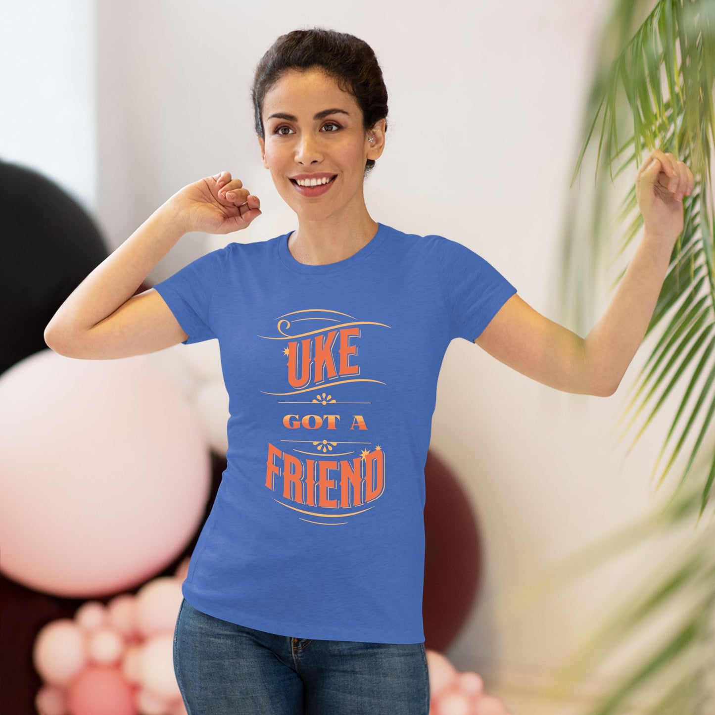 Woman wearing a royal blue t-shirt with ‘Uke Got A Friend' in orange block letters printed on it.