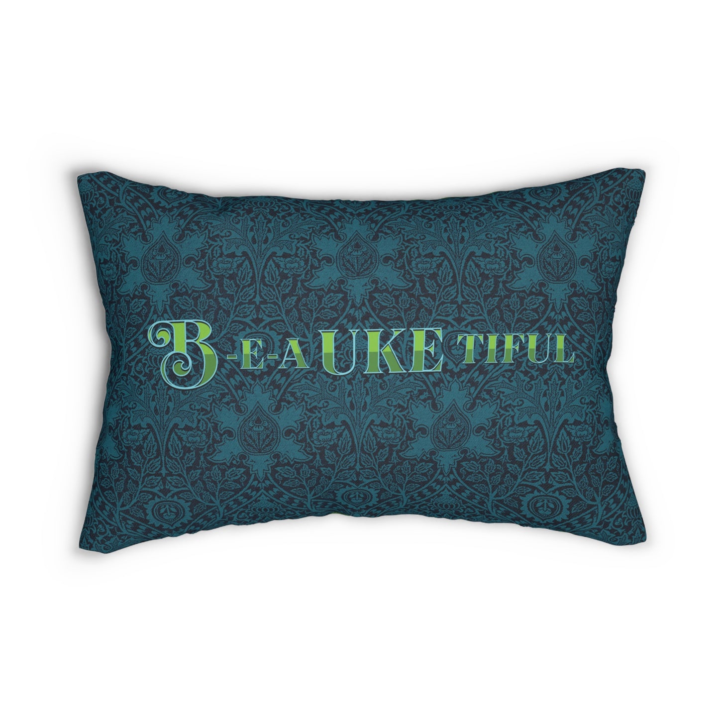 A throw pillow with a dark teal patterned background and 'B-E-A-UKE-tiful' in bold green letters printed on it.