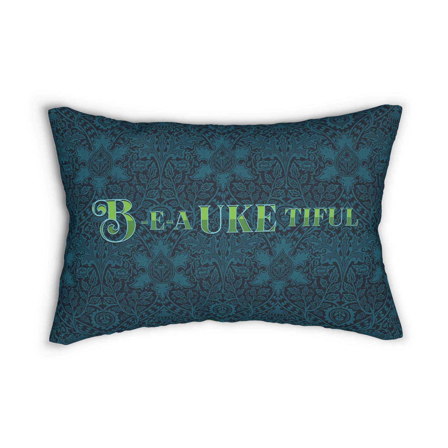 A throw pillow with a dark teal patterned background and 'B-E-A-UKE-tiful' in bold green letters printed on it.