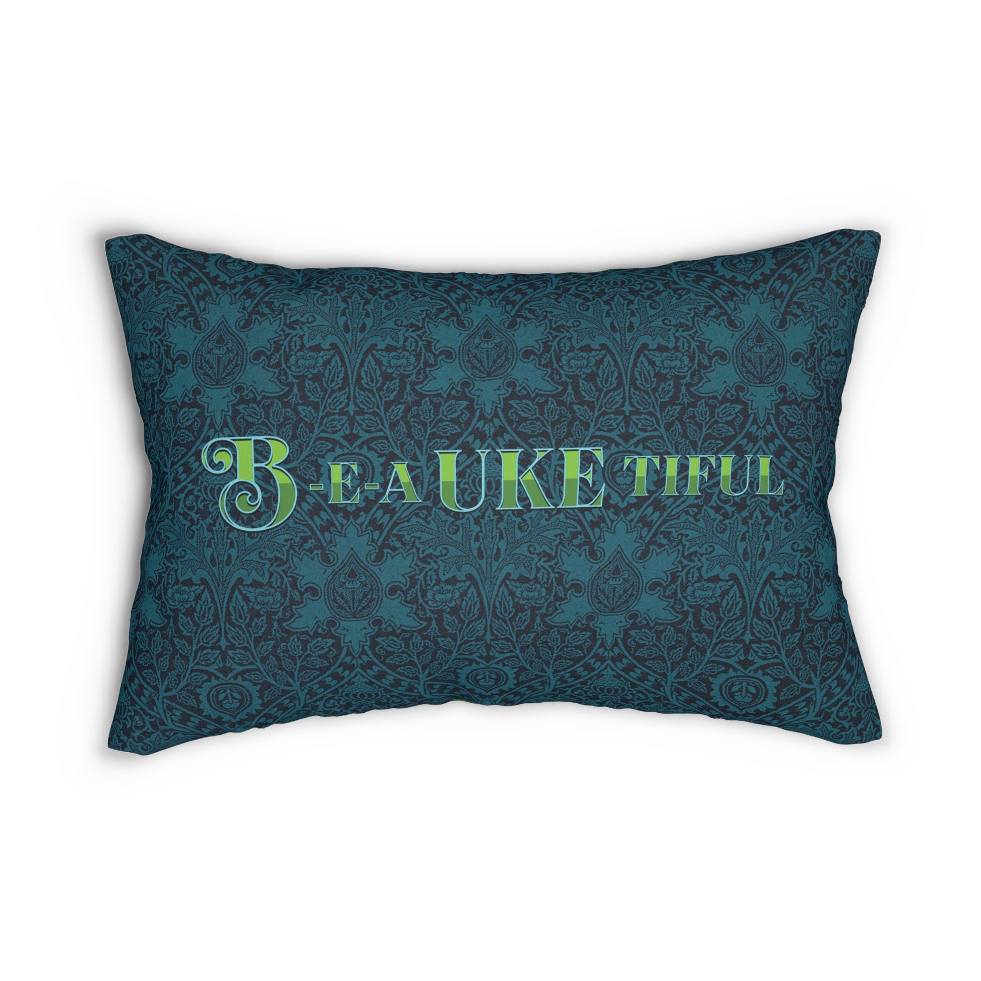 A throw pillow with a dark teal patterned background and 'B-E-A-UKE-tiful' in bold green letters printed on it.