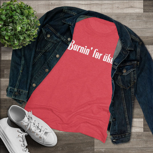 Red t-shirt with 'Burnin' for uke' in white Gothic letters printed on it, styled with a denim jacket and white sneakers.