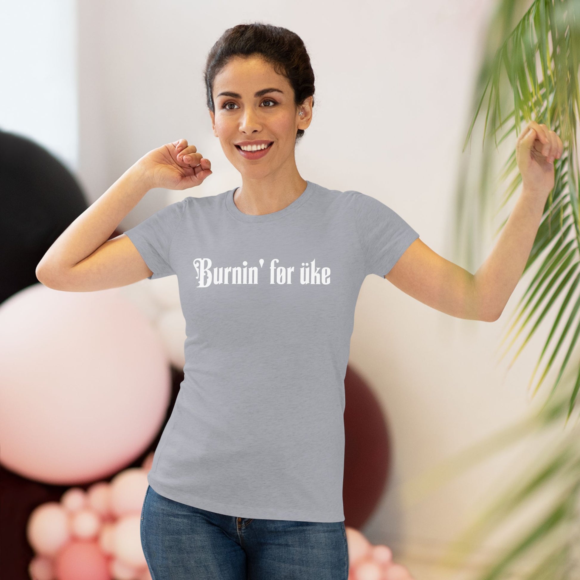 Woman wearing a grey t-shirt with 'Burnin' for uke' in white Gothic letters printed on it.