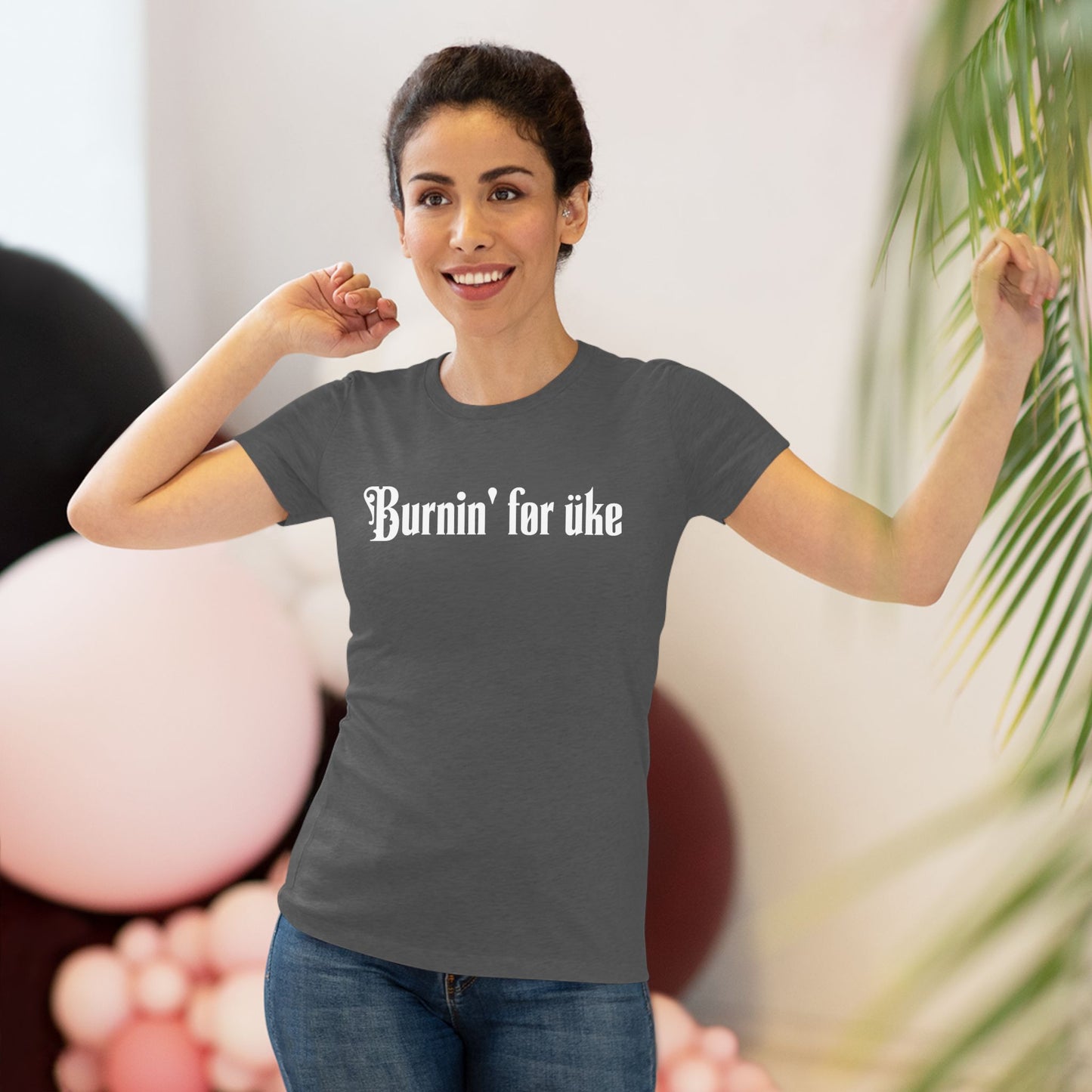 Woman wearing a heathered black t-shirt with 'Burnin' for uke' in white Gothic letters printed on it.
