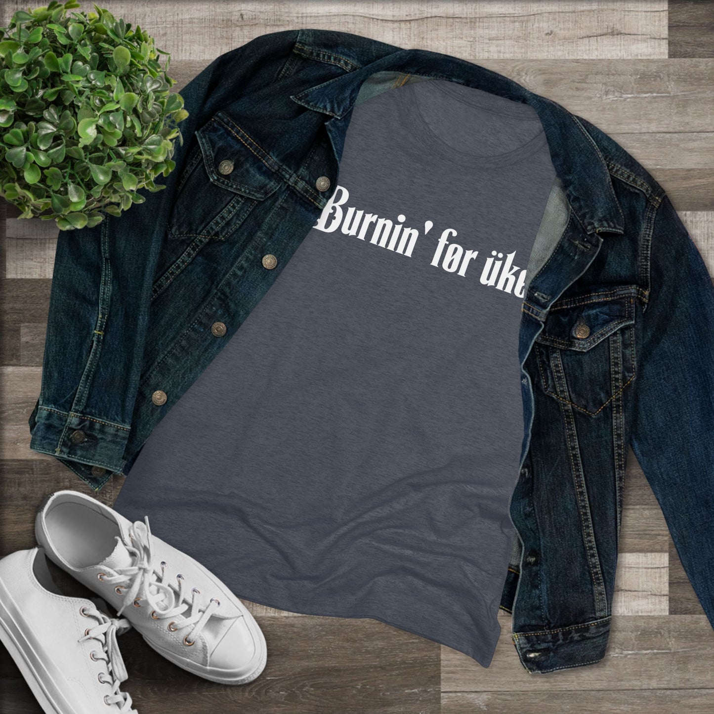 Heathered navy t-shirt with 'Burnin' for uke' in white Gothic letters printed on it, styled with a denim jacket and white sneakers.