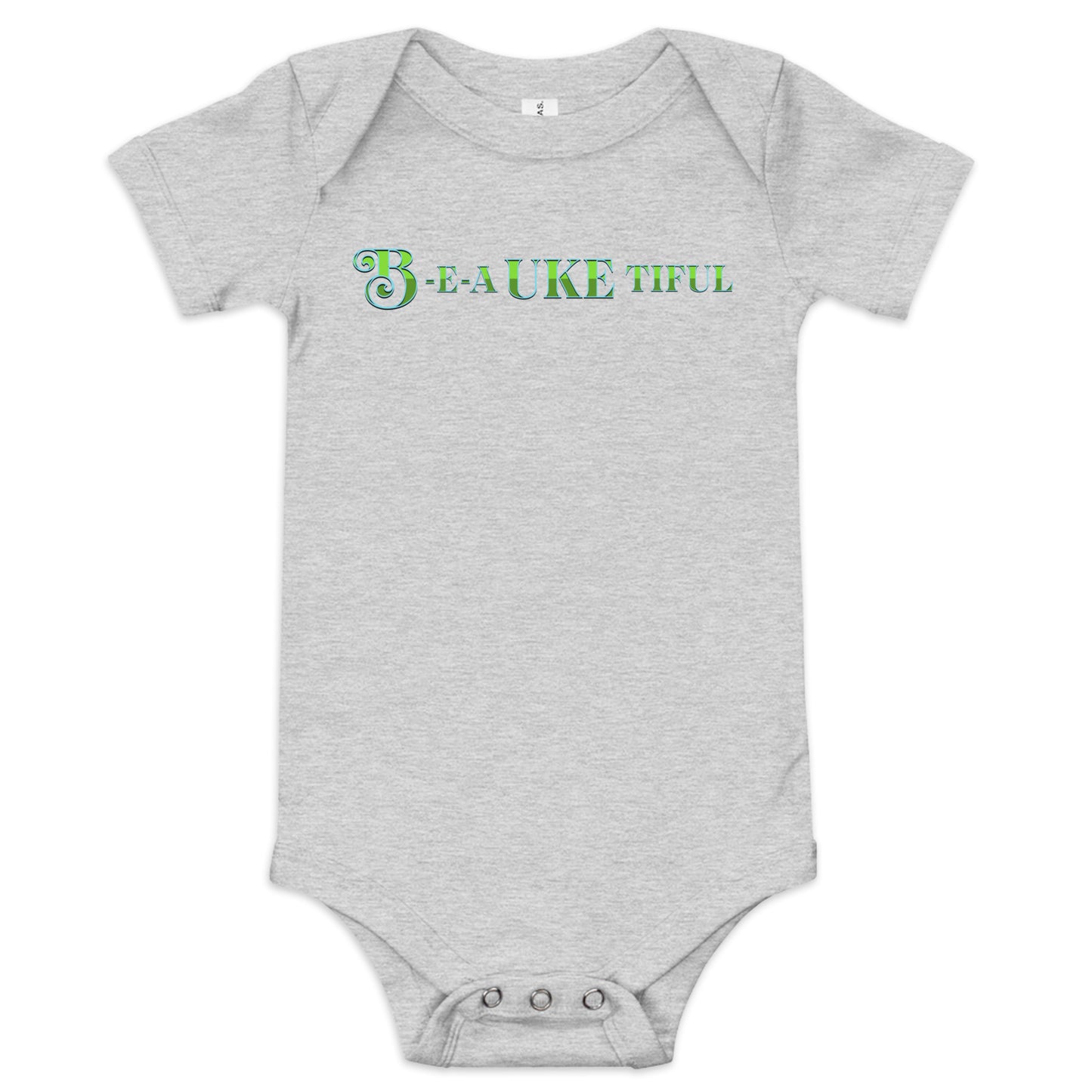 Light grey baby onesie with ‘B-E-A-UKE-tiful’ printed in green block letters with a decorative letter B.