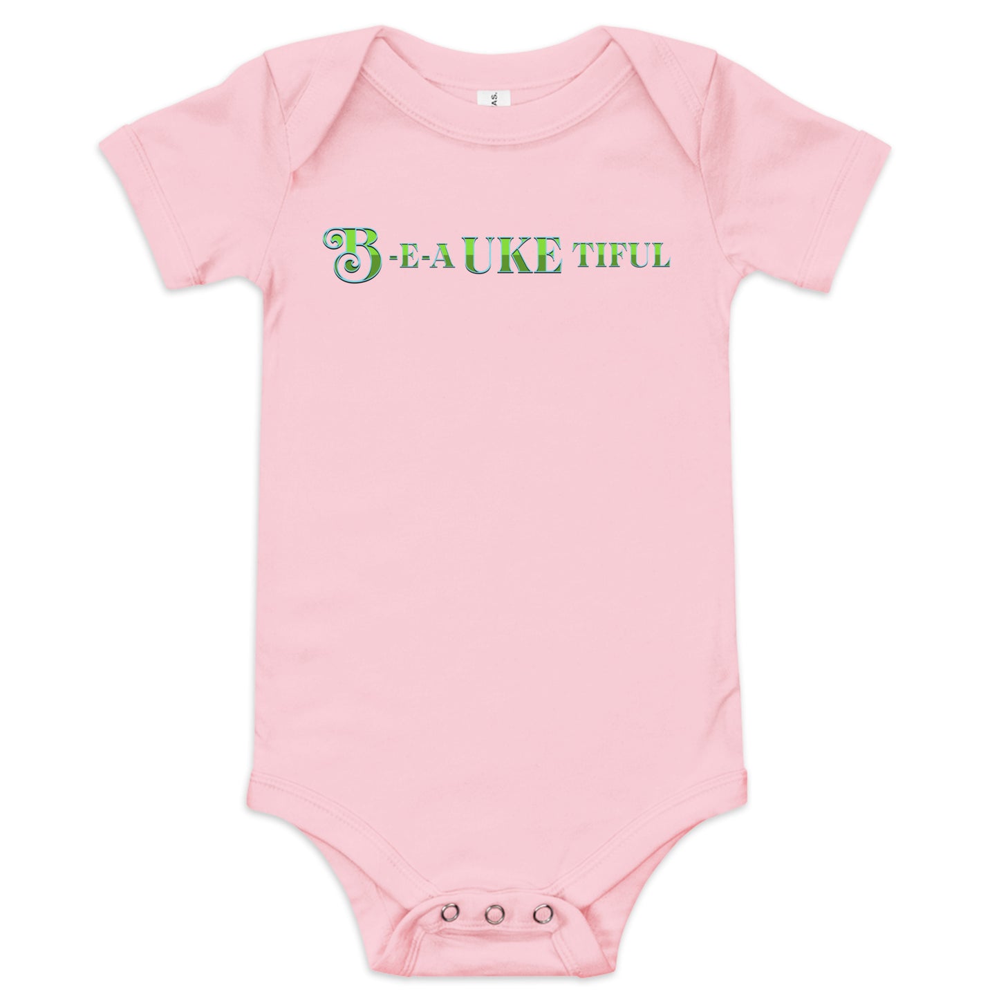 Light pink baby onesie with ‘B-E-A-UKE-tiful’ printed in green block letters with a decorative letter B.
