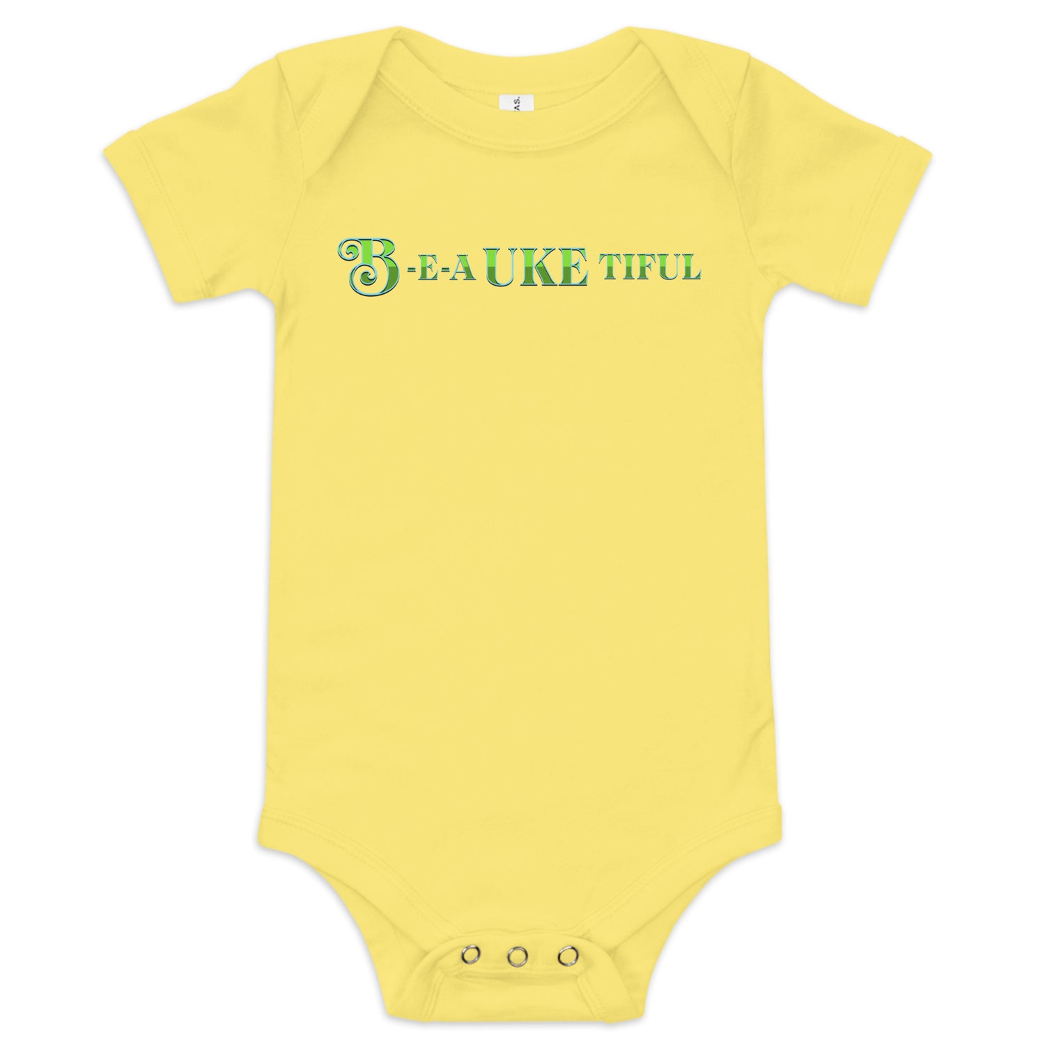 Yellow baby onesie with ‘B-E-A-UKE-tiful’ printed in green block letters with a decorative letter B.