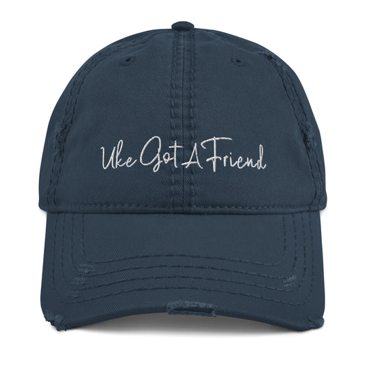 Navy-blue baseball cap with a distressed look and 'Uke Got A Friend' embroidered on it with white thread.