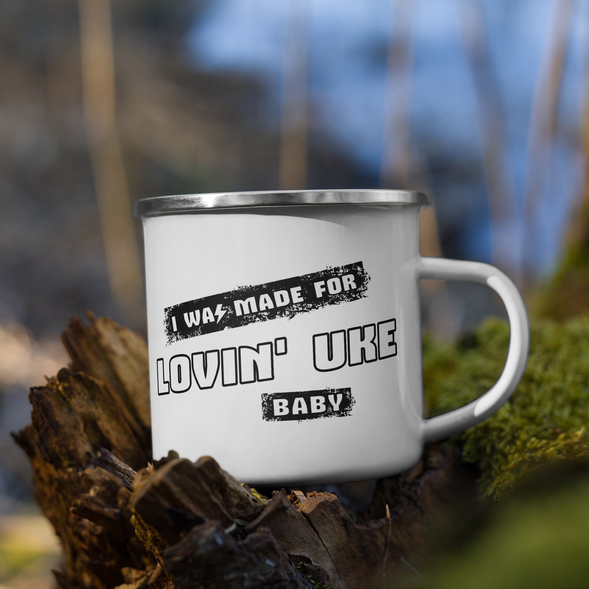 A white enamel mug with 'I was made for lovin' uke, Baby' printed in black and white block letters.