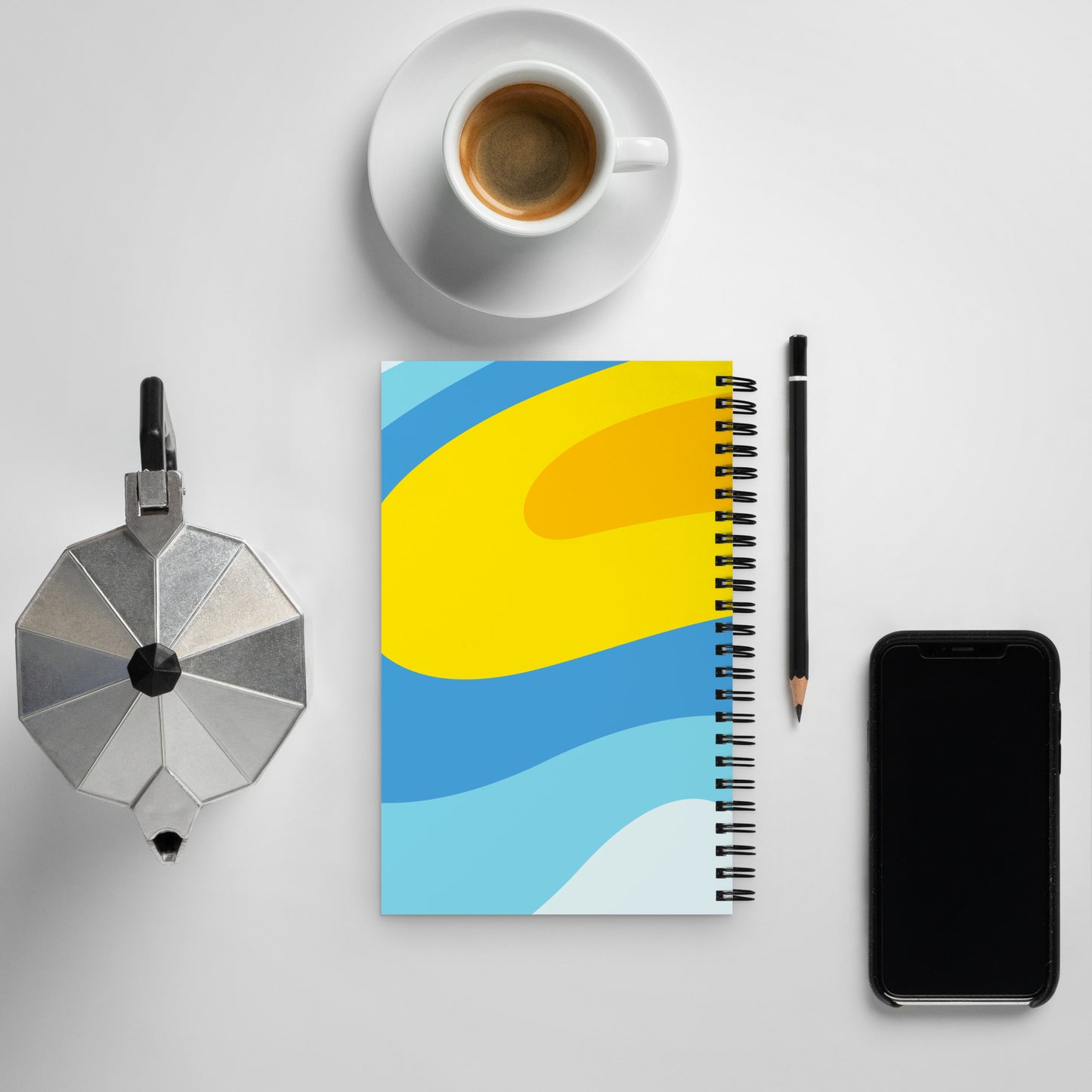 The backside of a 5-by-7 inch notebook with a swirly blue and yellow background.