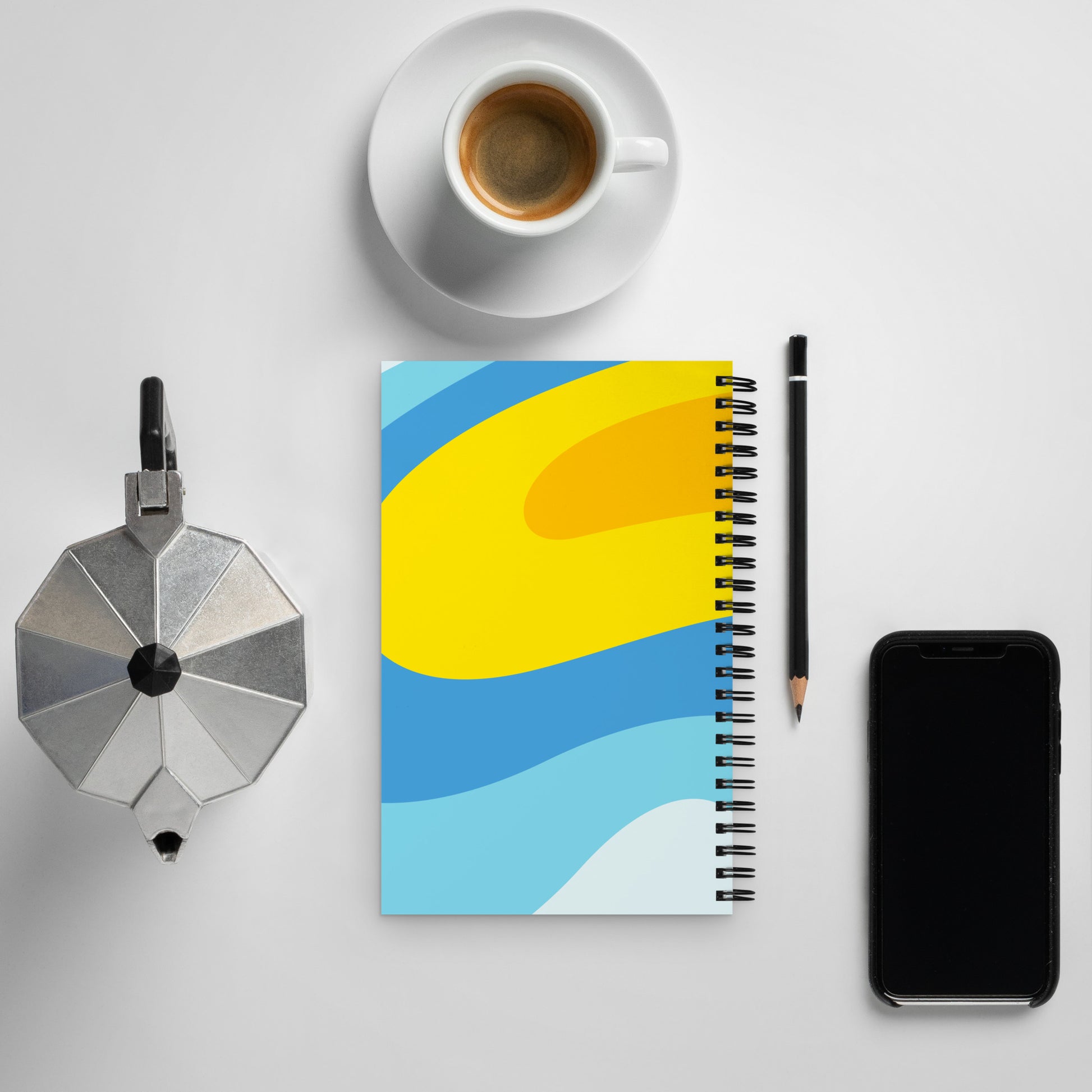 The backside of a 5-by-7 inch notebook with a swirly blue and yellow background.