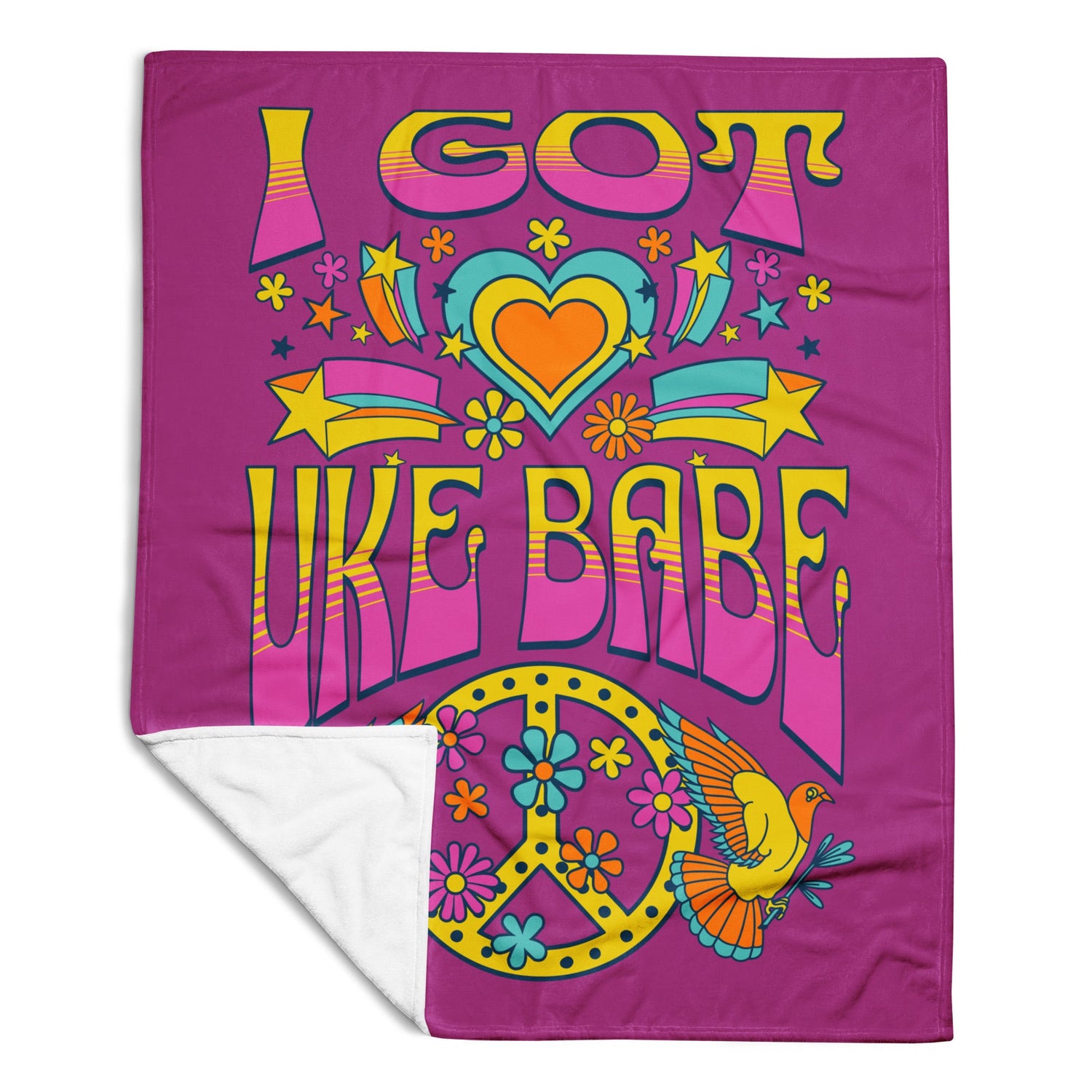 A microplush throw blanket with a deep pink background and 'I Got Uke Babe' and a blue, pink, and yellow peace sign graphic printed on it.
