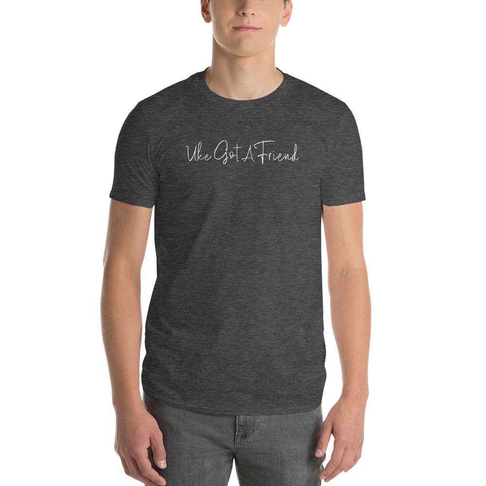 Man wearing a dark grey t-shirt printed with 'Uke Got A Friend' in white cursive text.