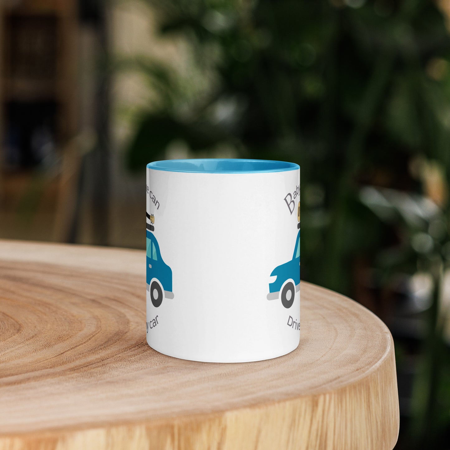 White mug with light blue handle and inside, with ‘Baby, uke can drive my car’ and a graphic of a car with a ukulele on the roof printed on the left and right sides of the handle.