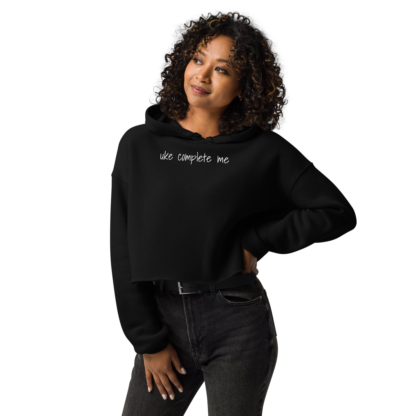 Woman wearing a black cropped hoodie with 'uke complete me' written in white text.
