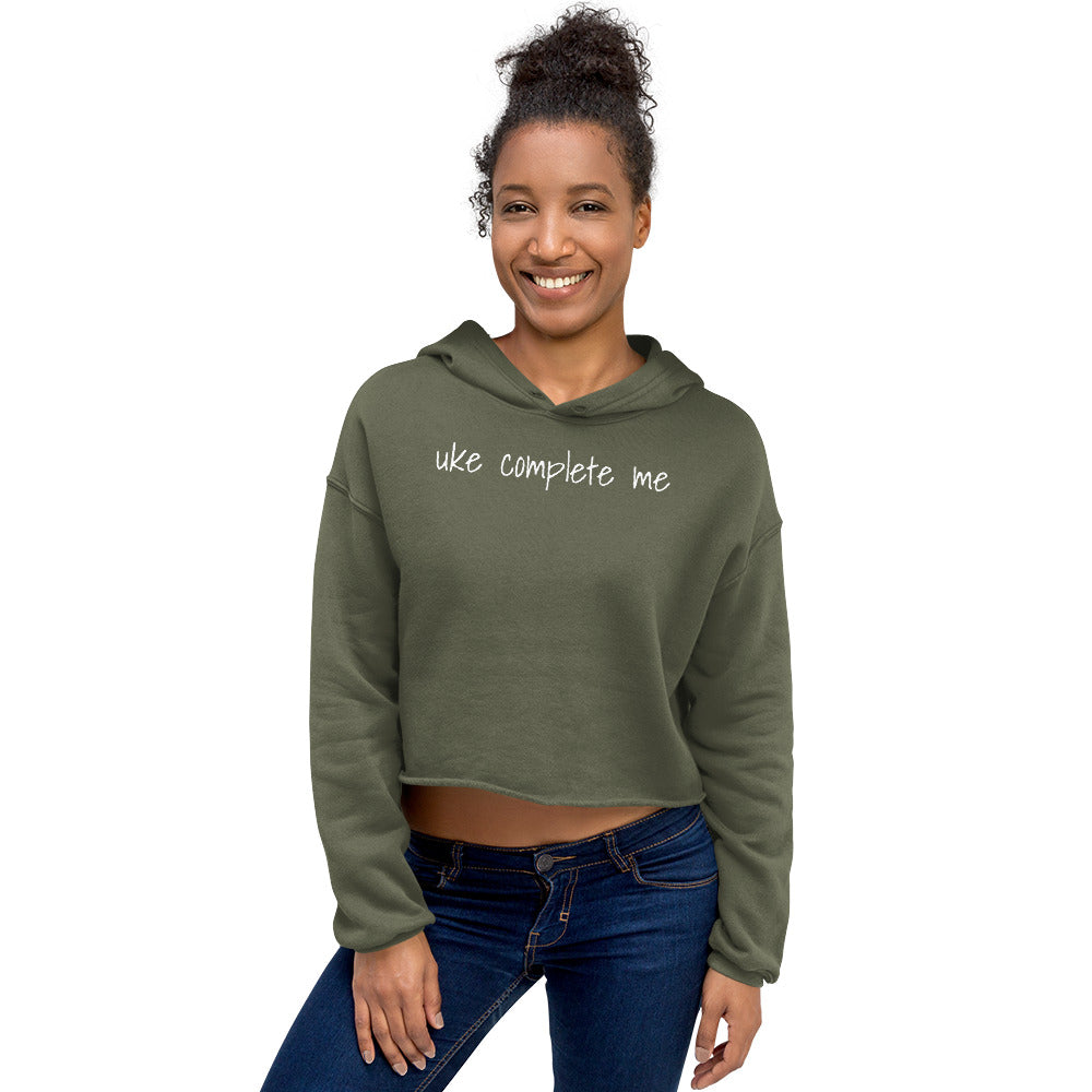 Woman wearing a Military Green cropped hoodie with 'uke complete me' written in white text.