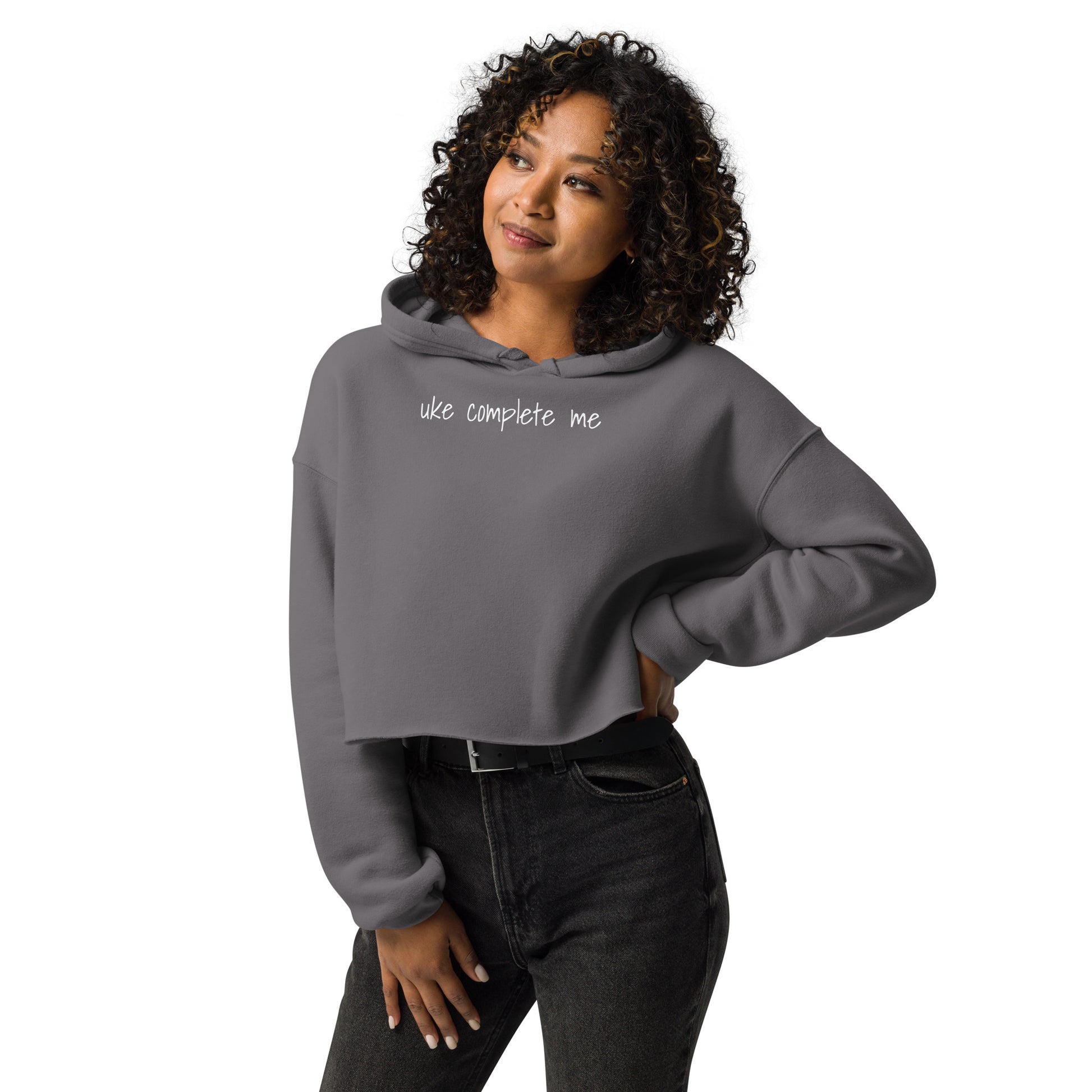 Woman wearing a Storm Front Grey cropped hoodie with 'uke complete me' written in white text.