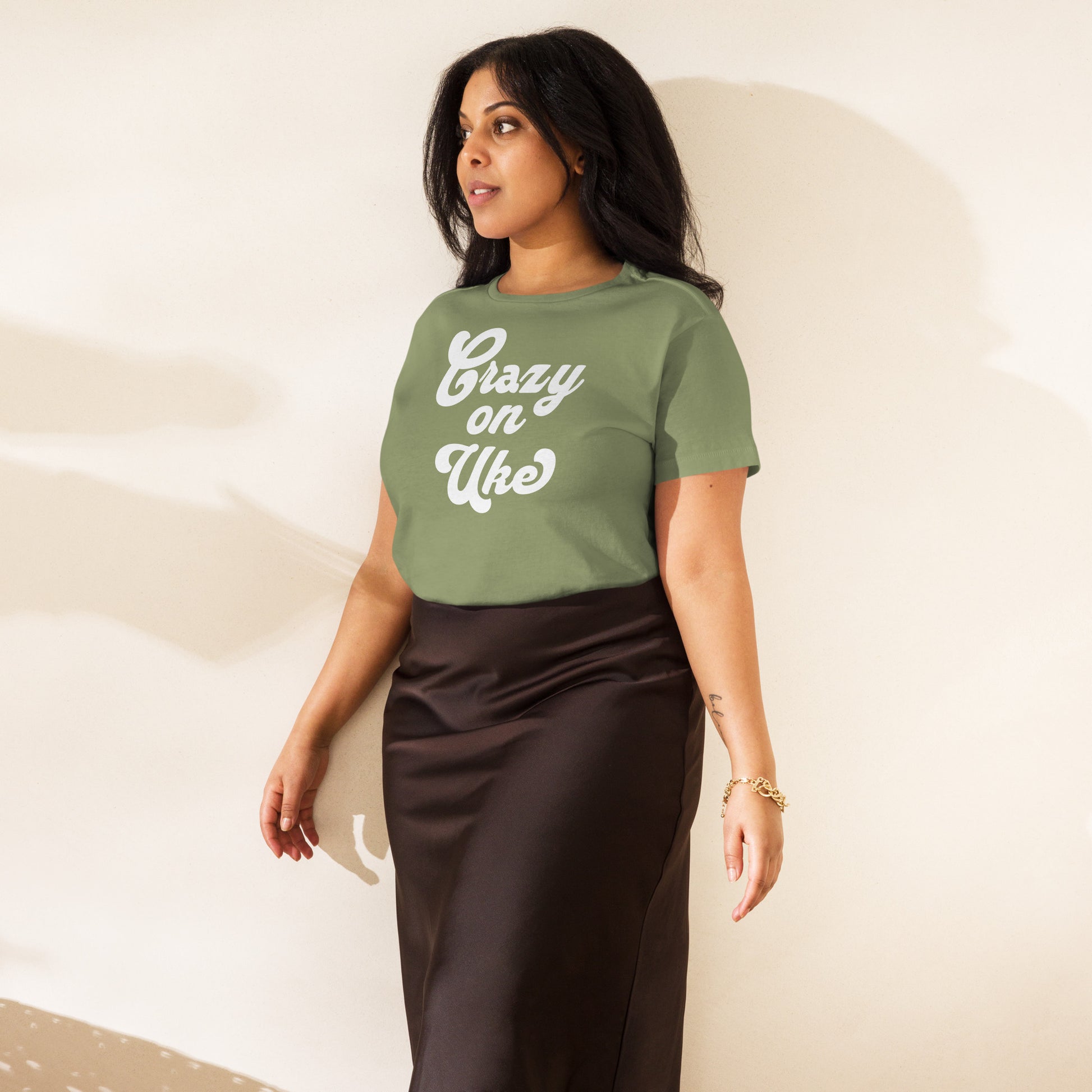 Woman wearing an artichoke-green high-waisted t-shirt with 'Crazy On Uke' in white cursive text.