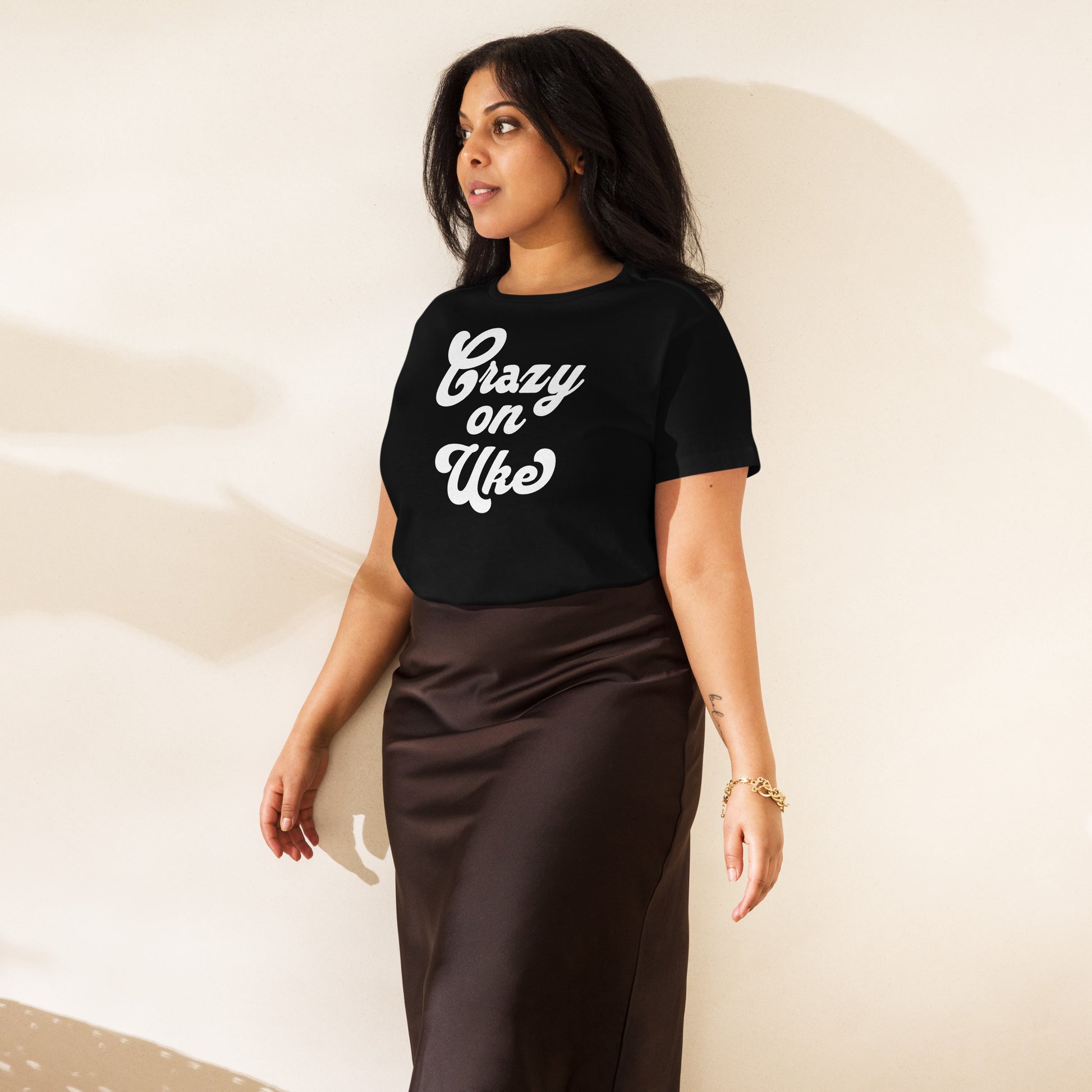 Woman wearing a black high-waisted t-shirt with 'Crazy On Uke' in white cursive text.