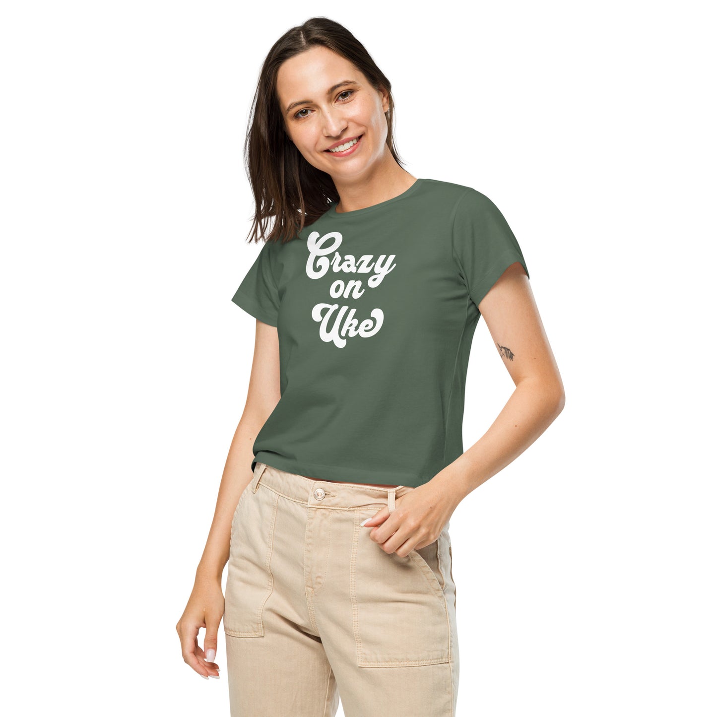 Woman wearing a pine-green high-waisted t-shirt with 'Crazy On Uke' in white cursive text.