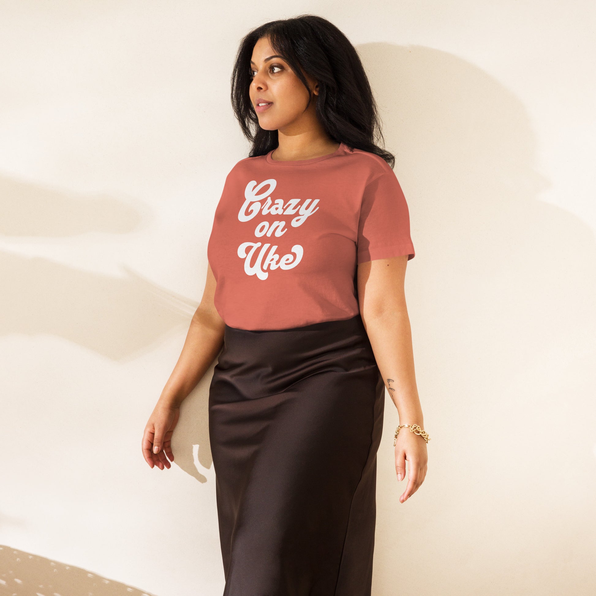 Woman wearing a red-sorbet-colored high-waisted t-shirt with 'Crazy On Uke' in white cursive text.