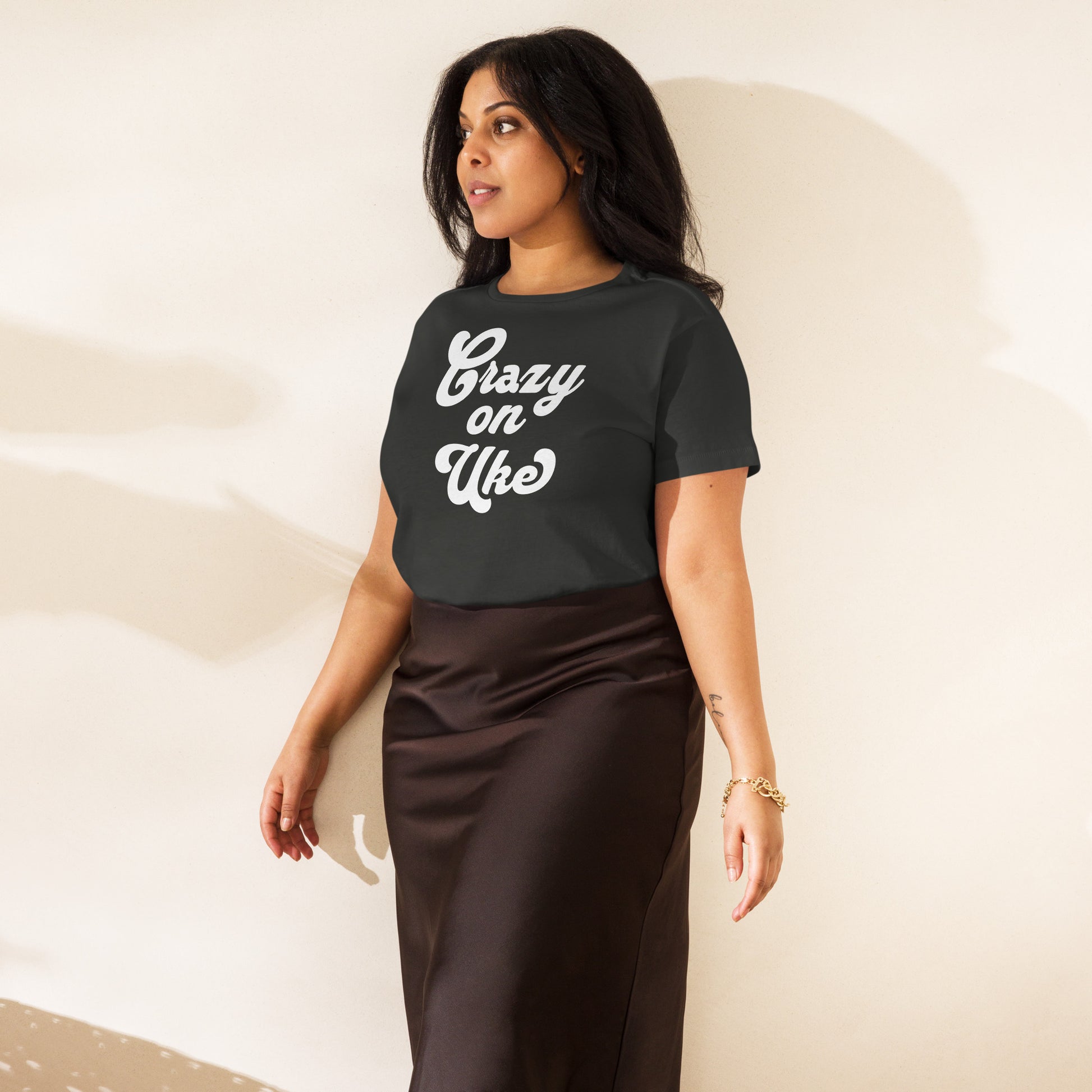 Woman wearing a vintage-black high-waisted t-shirt with 'Crazy On Uke' in white cursive text.
