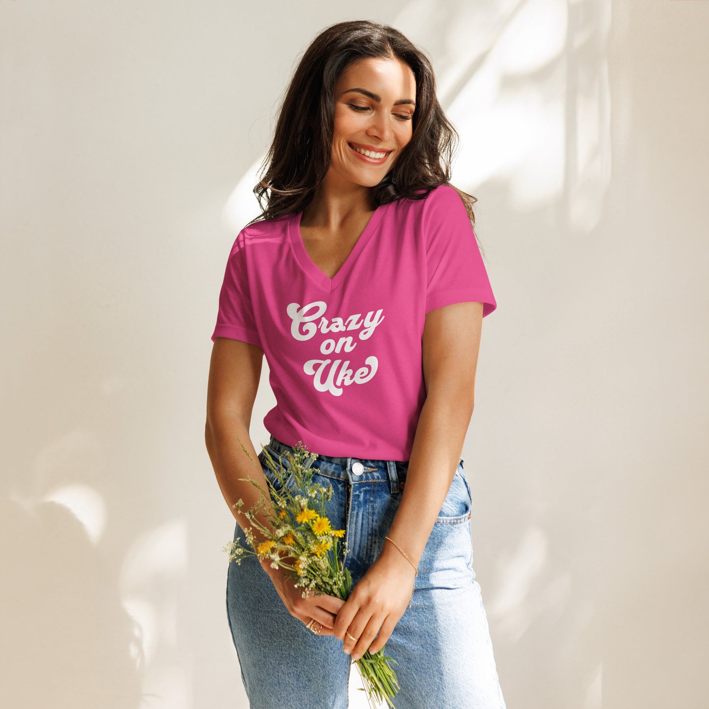 Woman wearing a berry pink v-neck t-shirt with 'Crazy On Uke' in white cursive text.