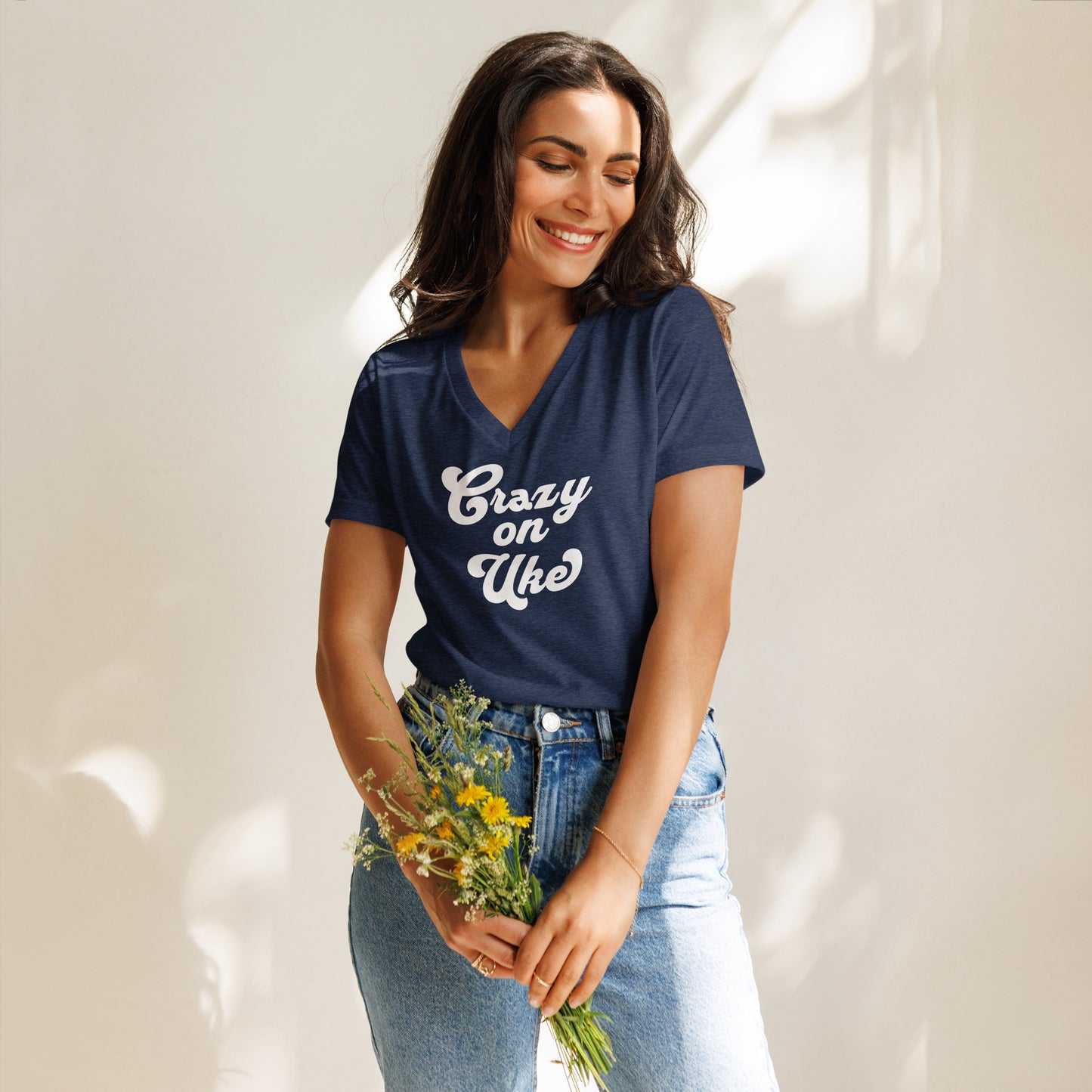 Woman wearing a heather navy blue v-neck t-shirt with 'Crazy On Uke' in white cursive text.