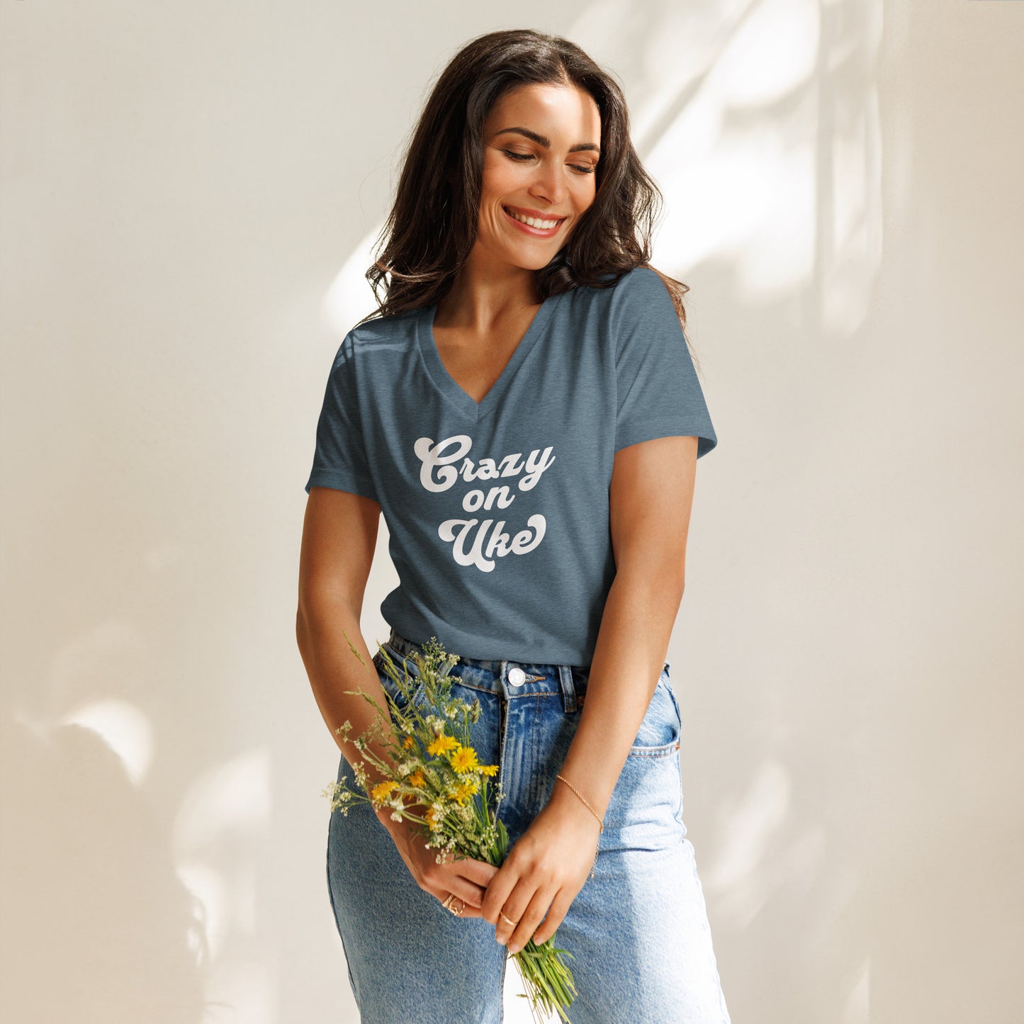 Woman wearing a heather slate blue-grey v-neck t-shirt with 'Crazy On Uke' in white cursive text.