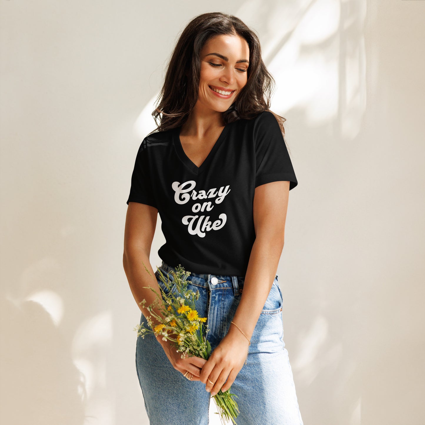 Woman wearing a black v-neck t-shirt with 'Crazy On Uke' in white cursive text.