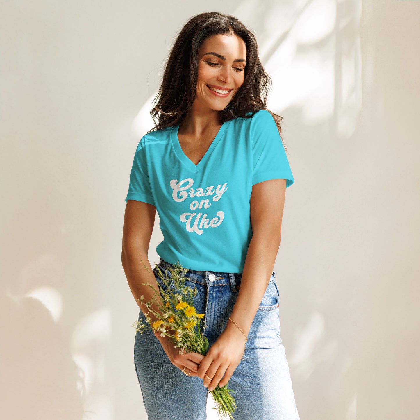 Woman wearing a turquoise v-neck t-shirt with 'Crazy On Uke' in white cursive text.